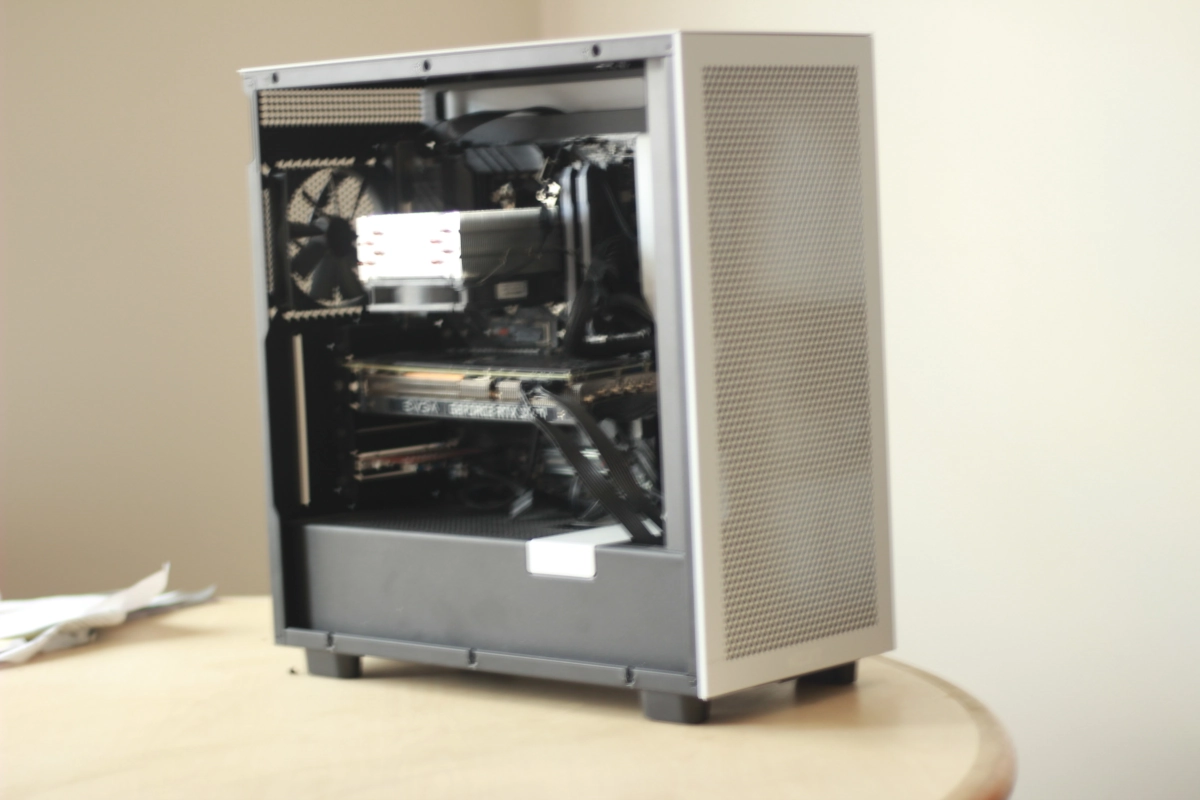 a white pc standing on a wooden table