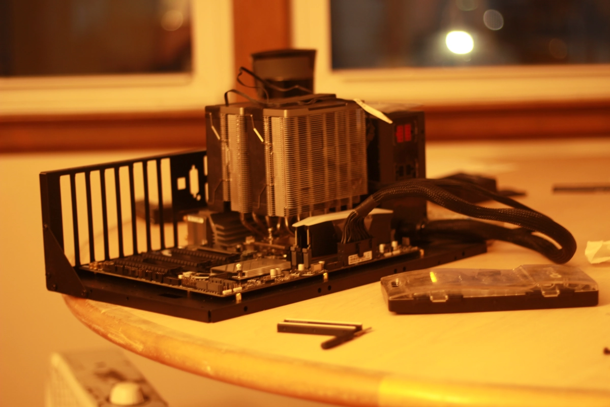 a white pc standing on a wooden table